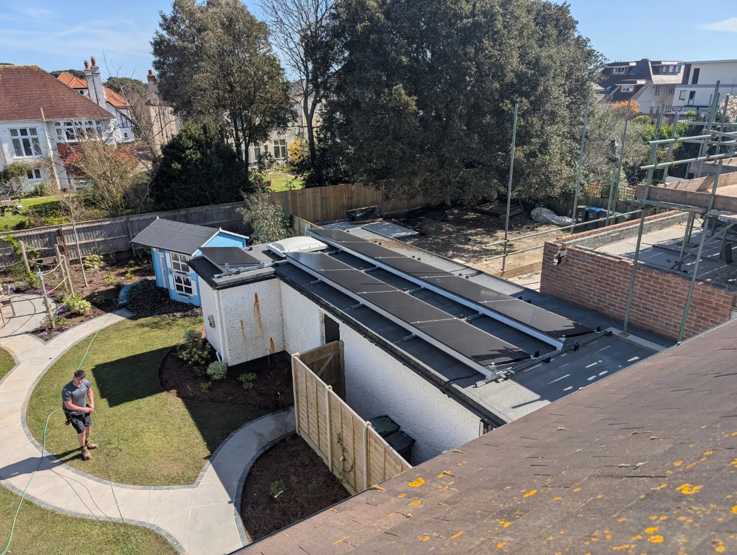 Aerial view of an EnviroHomes flat-roof solar installation