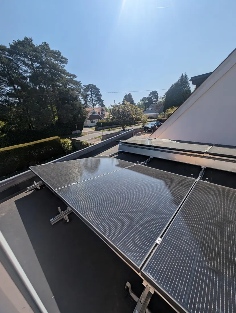 Close view of solar modules on flat roof mounting frames