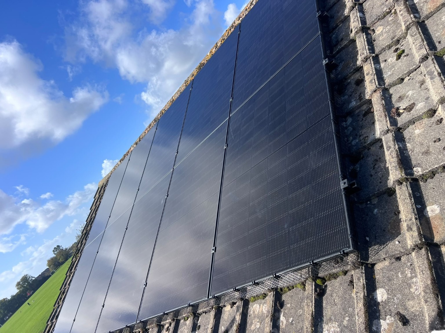 Real EnviroHomes all-black rooftop solar installation