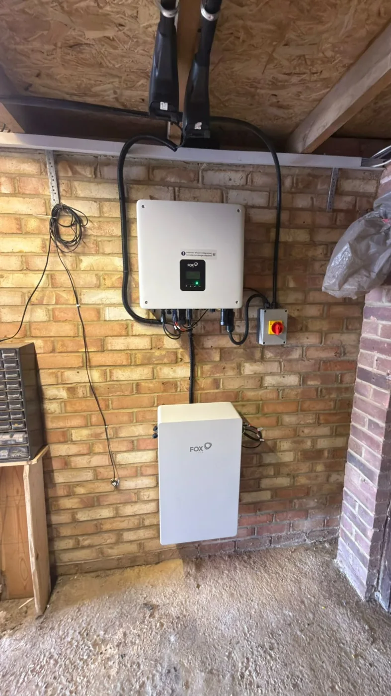 Fox ESS hybrid inverter and battery on brick wall